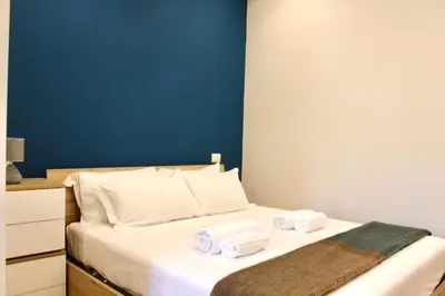 a bedroom with a bed with towels on it at HC - Miriam's Brand New Apartment in Vatican in Rome