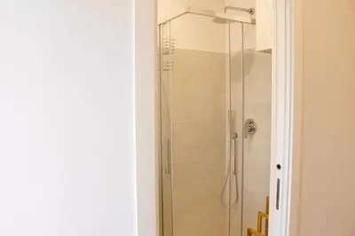 a shower with a glass door in a bathroom at HC - Miriam's Brand New Apartment in Vatican in Rome