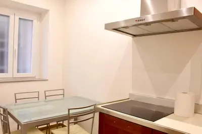 a kitchen with a sink and a table at HC - Miriam's Brand New Apartment in Vatican in Rome