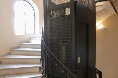 a staircase in a house with a black door at HC - Miriam's Brand New Apartment in Vatican in Rome