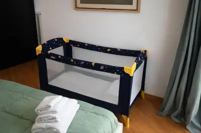 a black and yellow bed frame in a room at LoL-ApartmenT, in the heart of Trastevere in Rome