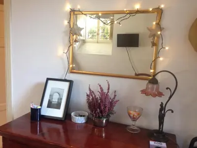 a wooden table with a mirror and lights on it at Casa Aventino in Rome