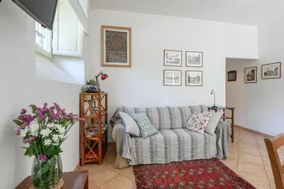 a living room with a couch and a vase of flowers at Casa Aventino in Rome
