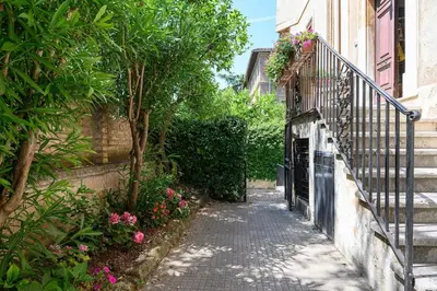 a small alley with a fence and flowers at Casa Aventino in Rome