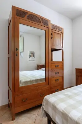 a large wooden dresser with a mirror in a bedroom at Casa Aventino in Rome