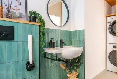 a bathroom with a sink and a washing machine at Family Rooms in Rome
