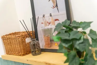 a table with a mirror and a plant and a vase at Family Rooms in Rome