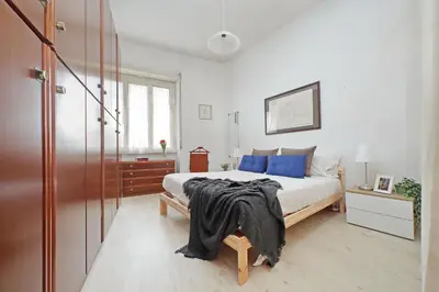 a bedroom with a bed with blue pillows at Casa Giannetta in Rome