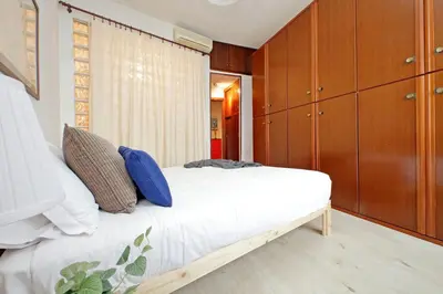 a bedroom with a bed and wooden cabinets at Casa Giannetta in Rome