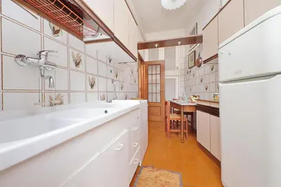 a kitchen with a white sink and a refrigerator at Casa Giannetta in Rome