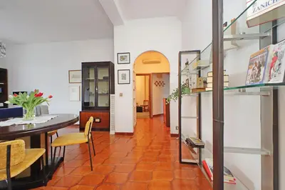 a room with a table and chairs and a hallway at Casa Giannetta in Rome