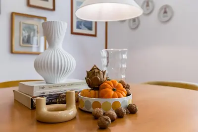 a kitchen with white cabinets and a wooden floor at Boutique Apartment in Vatican in Rome