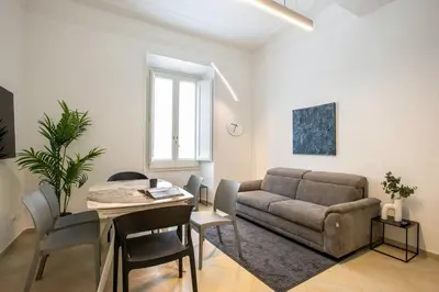 a living room with a couch and a table at Residenza Gradinata al Vaticano in Rome