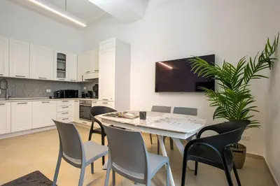 a kitchen and dining room with a table and chairs at Residenza Gradinata al Vaticano in Rome