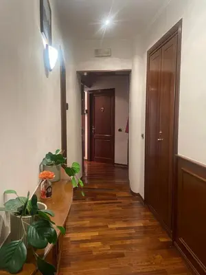 a hallway with a wooden floor and a door at Rome Opera Theatre Rooms by Dama - Termini Station & Rome City Center in Rome