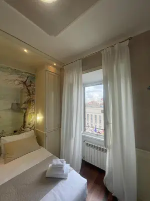 a bedroom with a bed and a large window at Rome Opera Theatre Rooms by Dama - Termini Station & Rome City Center in Rome