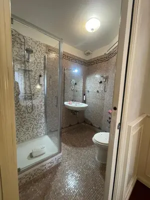 a bathroom with a shower and a toilet and a sink at Rome Opera Theatre Rooms by Dama - Termini Station & Rome City Center in Rome