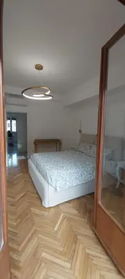 a bedroom with a bed on a wooden floor at Dodo's luxury house in Santa Maria Maggiore in Rome