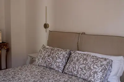 a bed with a pillow on top of it at Dodo's luxury house in Santa Maria Maggiore in Rome