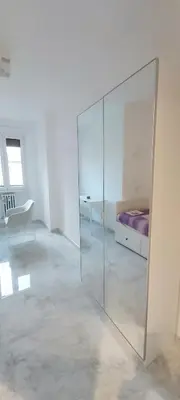 a white room with a bed and a glass wall at Dodo's luxury house in Santa Maria Maggiore in Rome