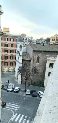 a view of a city with cars parked in a parking lot at Dodo's luxury house in Santa Maria Maggiore in Rome