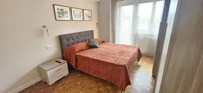 a small bedroom with a bed with a red blanket at Anastasio Terrace double 3 in Rome