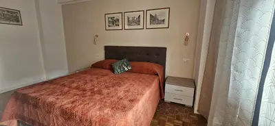 a bedroom with a bed with a orange bedspread at Anastasio Terrace double 3 in Rome