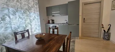 a kitchen with a wooden table and a dining room at Anastasio Terrace double 3 in Rome