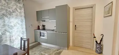 a kitchen with a door leading to a dining room at Anastasio Terrace double 3 in Rome