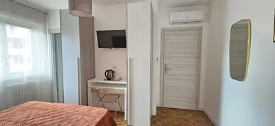 a bedroom with a bed and a desk and a mirror at Anastasio Terrace double 3 in Rome