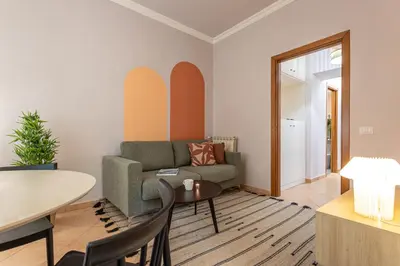 a living room with a couch and a table at Giardino Privato & Comfort - Oasi di Relax a Roma in Rome