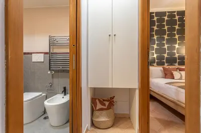 a small bathroom with a bed and a toilet and a sink at Giardino Privato & Comfort - Oasi di Relax a Roma in Rome