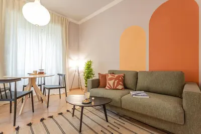 a living room with a couch and a table at Giardino Privato & Comfort - Oasi di Relax a Roma in Rome