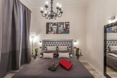 a bedroom with a large bed with shoes on it at St. George's Vatican Suites in Rome