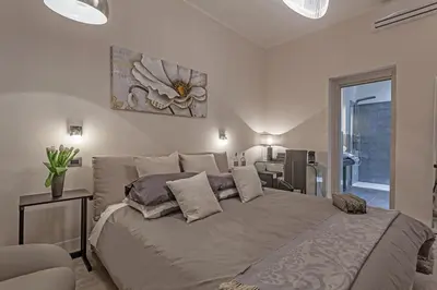 a bedroom with a large bed with pillows on it at St. George's Vatican Suites in Rome