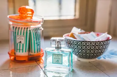 a bottle of perfume and a bowl on a table at Vatican's bijoux in Rome