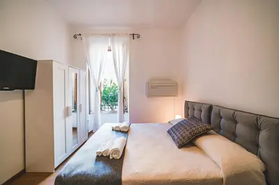 a bedroom with a large bed with towels on it at Vatican's bijoux in Rome