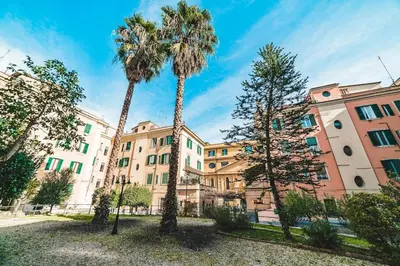 two palm trees in front of a building at Vatican's bijoux in Rome