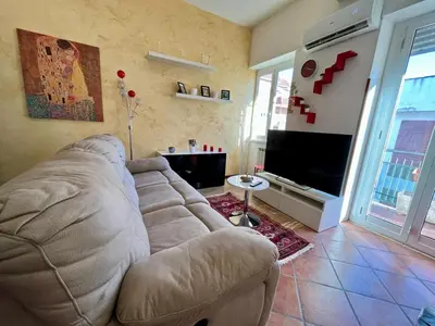 a living room with a couch and a flat screen tv at Domus Roma Apartment in Rome