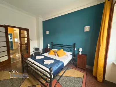 a bedroom with a bed with a blue wall at Satrico43 - San Giovanni Stay in Rome