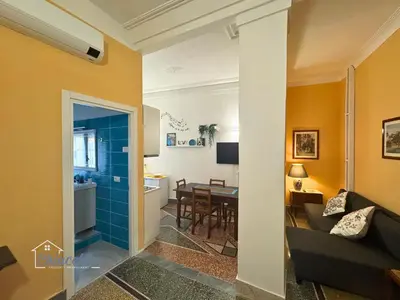a living room with a couch and a dining room at Satrico43 - San Giovanni Stay in Rome