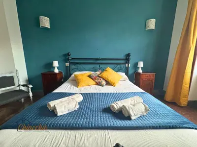 a bedroom with a bed with two towels on it at Satrico43 - San Giovanni Stay in Rome