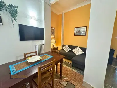 a living room with a table and a couch at Satrico43 - San Giovanni Stay in Rome