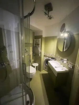 a bathroom with a shower and a toilet and a sink at Testaccio Stay - your home in the heart of Rome in Rome
