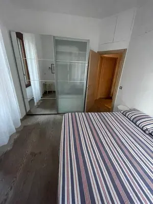 a bedroom with a striped bed and a glass door at Testaccio Stay - your home in the heart of Rome in Rome