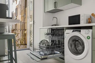 a laundry room with a washing machine in a kitchen at Visconti58 Boutique House - Modern apt with balcony in Rome