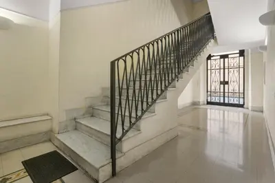 a staircase in a white room with a metal railing at Visconti58 Boutique House - Modern apt with balcony in Rome