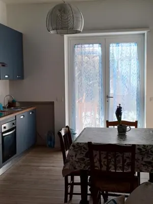 a kitchen and dining room with a table and a window at Il giardino dell'Eden 10 - Alloggio Turistico in Rome