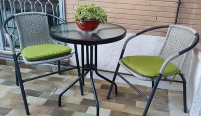 a table and chairs with a potted plant on a patio at Il giardino dell'Eden 10 - Alloggio Turistico in Rome
