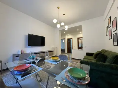 a living room with a glass table with plates on it at Flaminia Apartment - Metro A in Rome